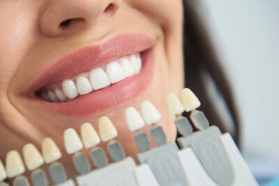 A woman smiles brightly .