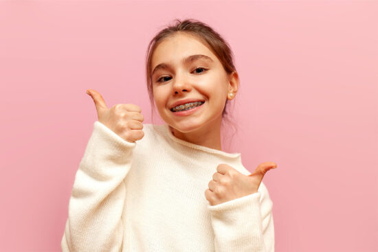 Kid smiling with braces.